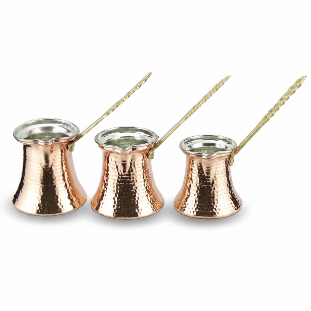 Hammered copper cezve set brass handle white background