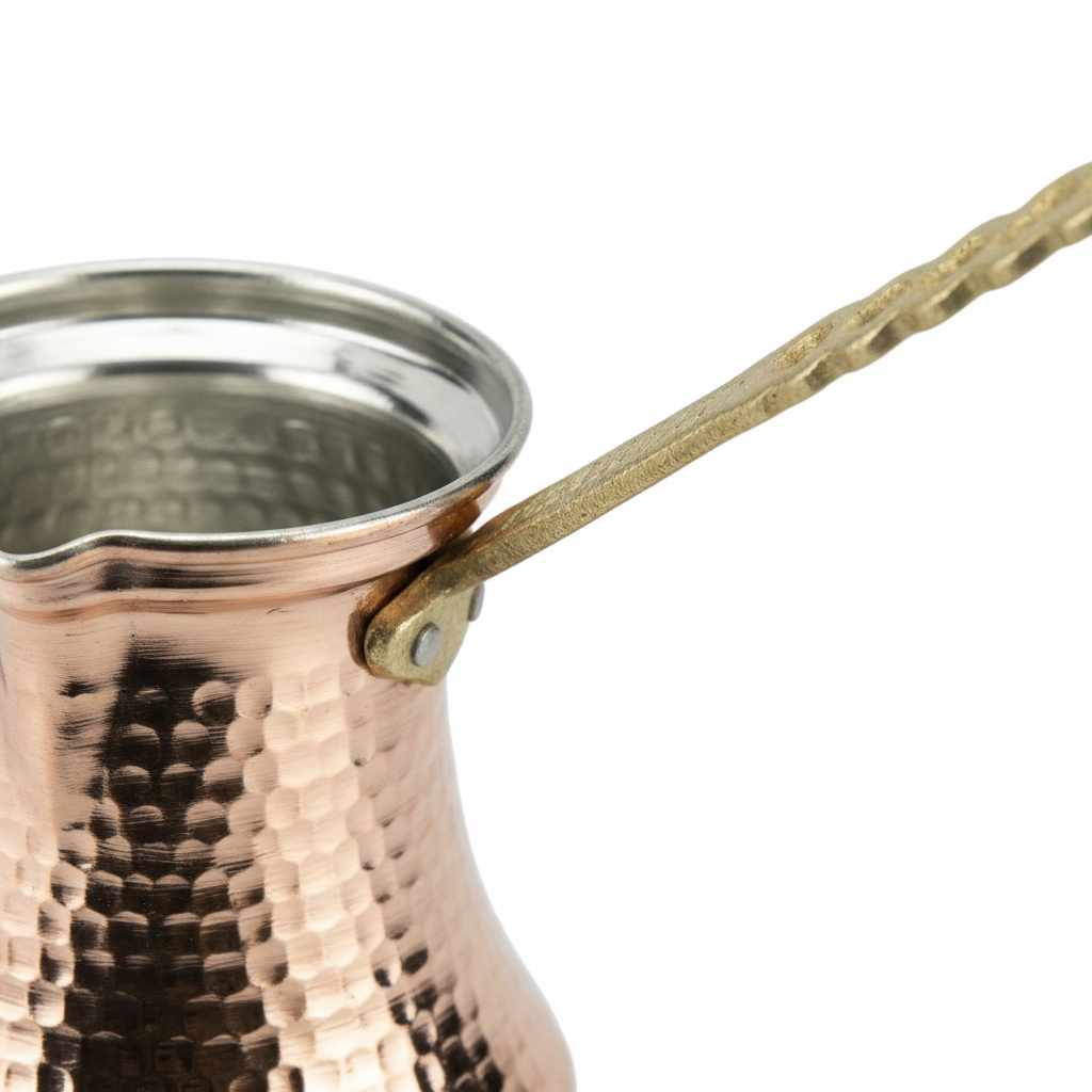Hammered copper cezve brass handle macro texture detail